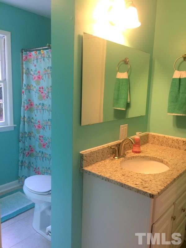 400 Compton Road Raleigh, NC 27609 - Photo 17 of 25 a bathroom with a granite countertop sink and a mirror