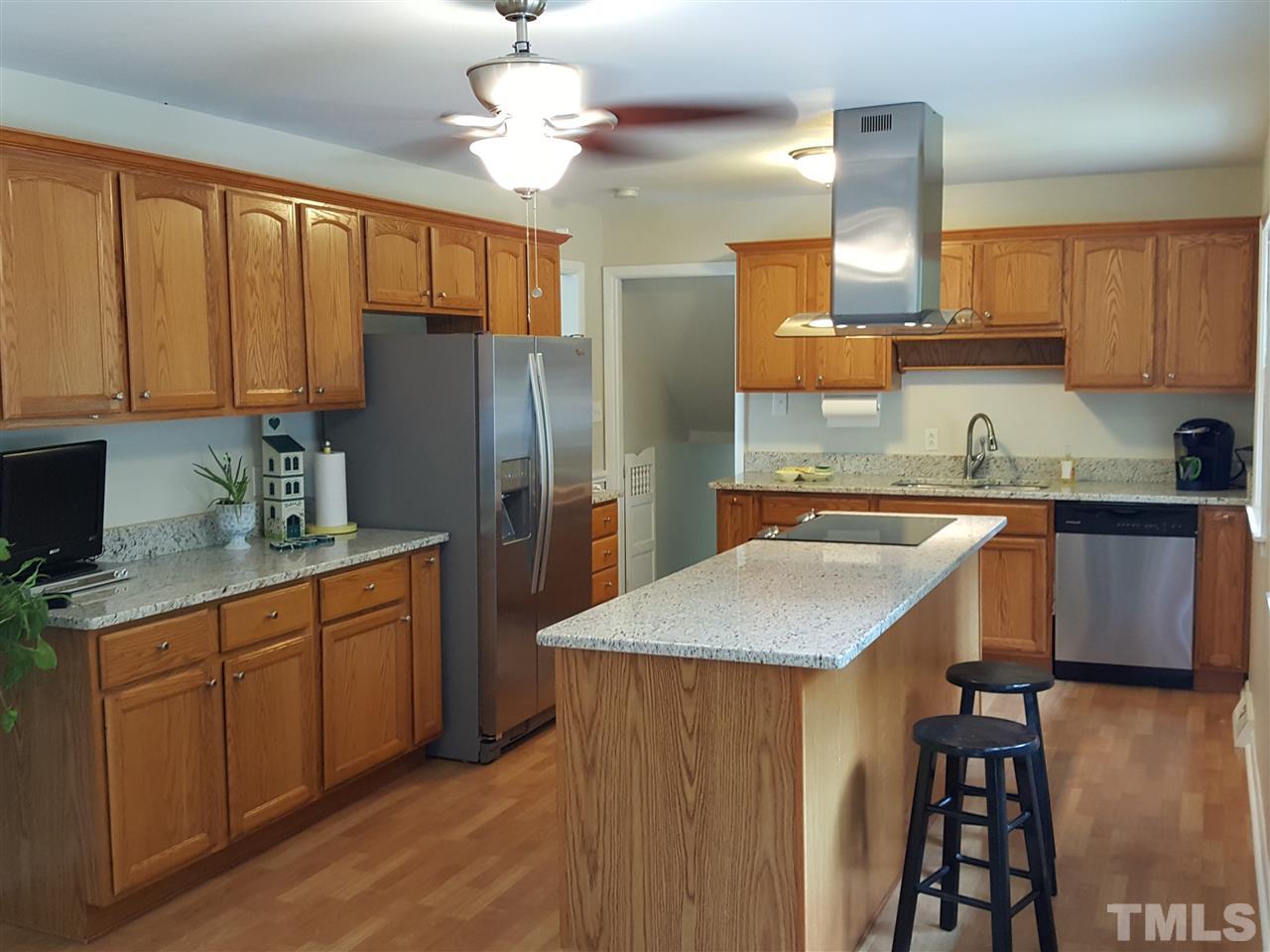 400 Compton Road Raleigh, NC 27609 - Photo 4 of 25 a kitchen with stainless steel appliances granite countertop a sink refrigerator and cabinets