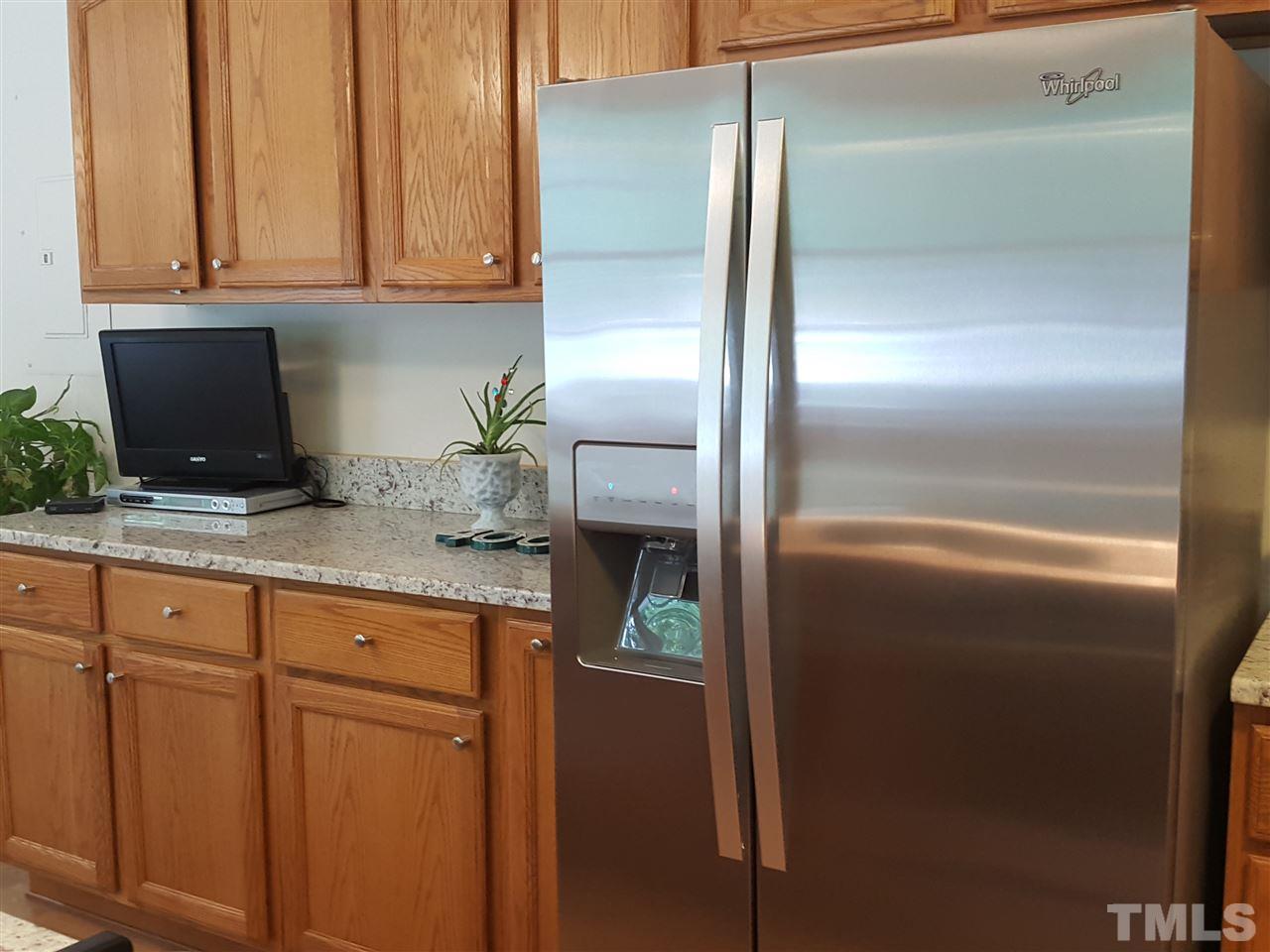 400 Compton Road Raleigh, NC 27609 - Photo 8 of 25 a kitchen with granite countertop stainless steel appliances and refrigerator