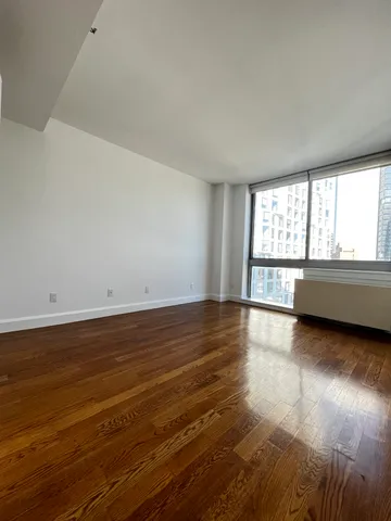 a view of a room with wooden floor and windows