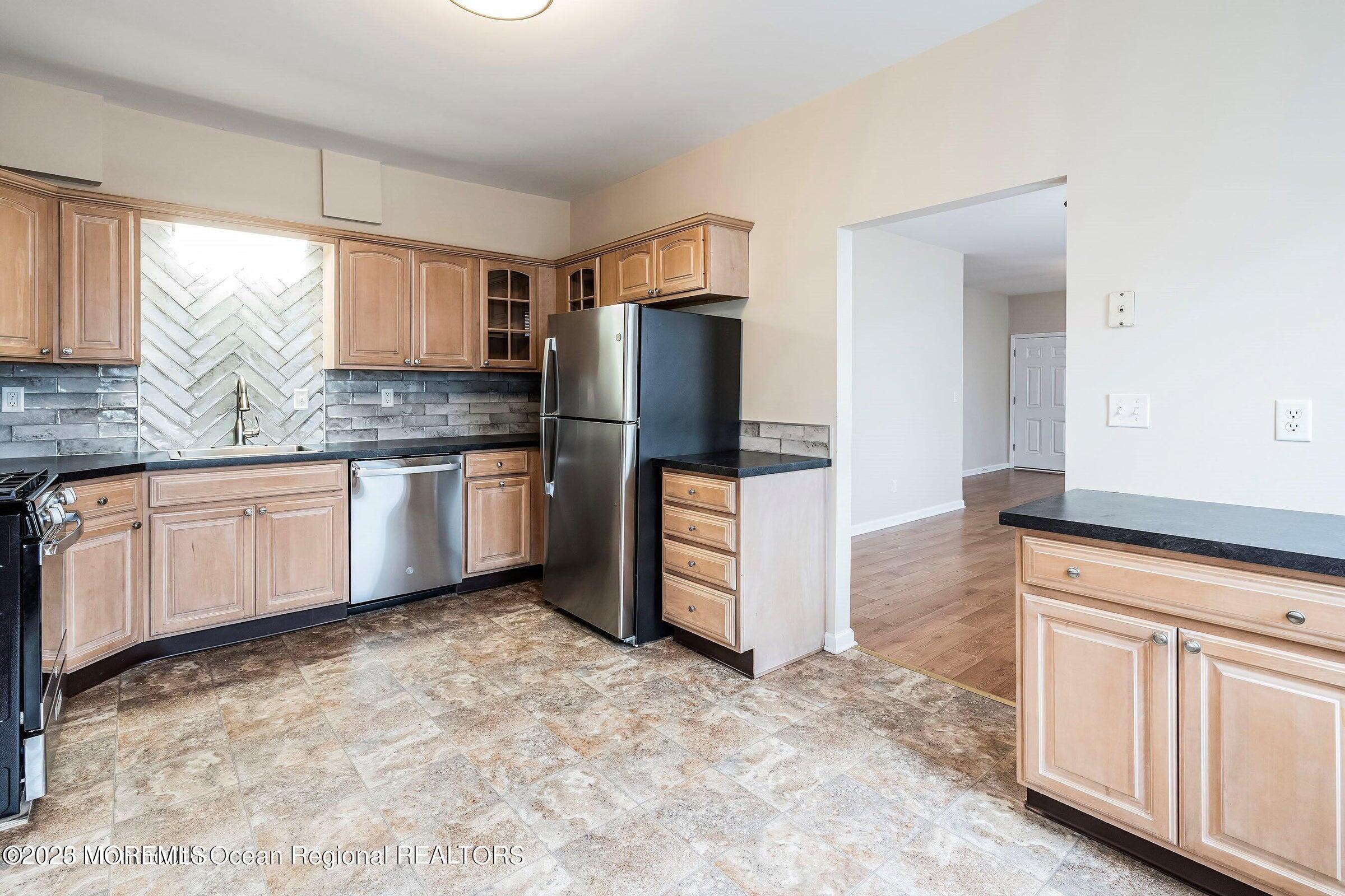 34 Bridge Avenue, Unit A Red Bank, NJ 07701 - Photo 12 of 27 a kitchen with stainless steel appliances granite countertop a refrigerator and a sink
