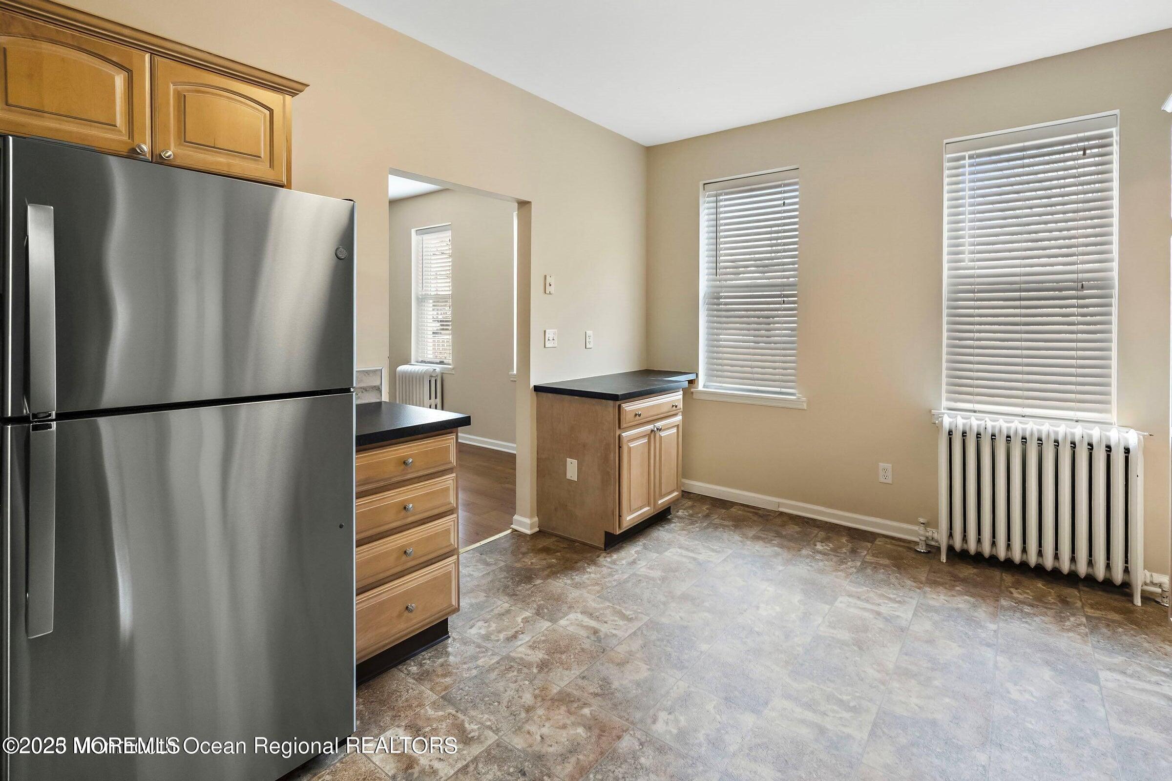 34 Bridge Avenue, Unit A Red Bank, NJ 07701 - Photo 13 of 27 a kitchen with stainless steel appliances a refrigerator and cabinets