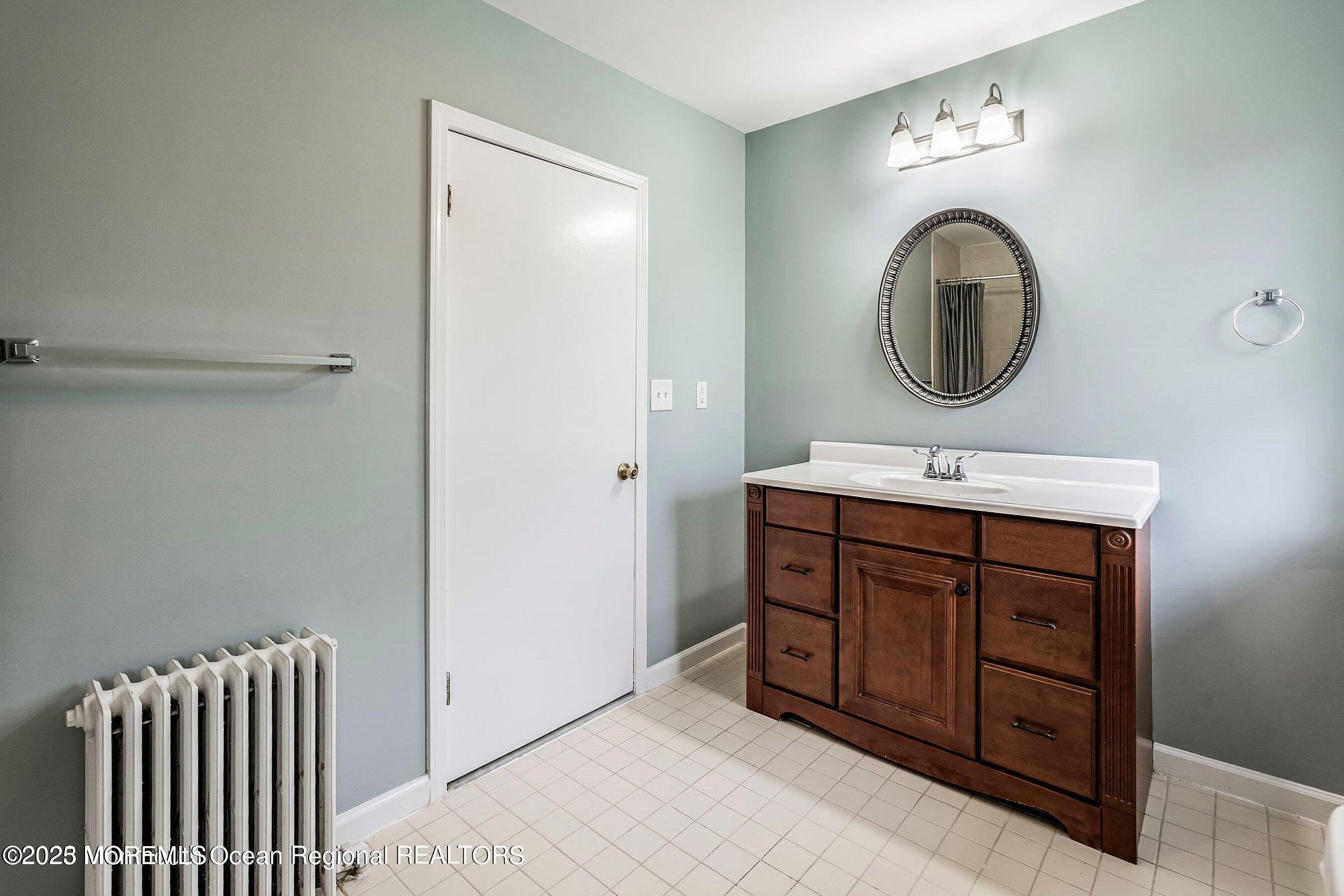 34 Bridge Avenue, Unit A Red Bank, NJ 07701 - Photo 20 of 27 a bathroom with a sink and a mirror