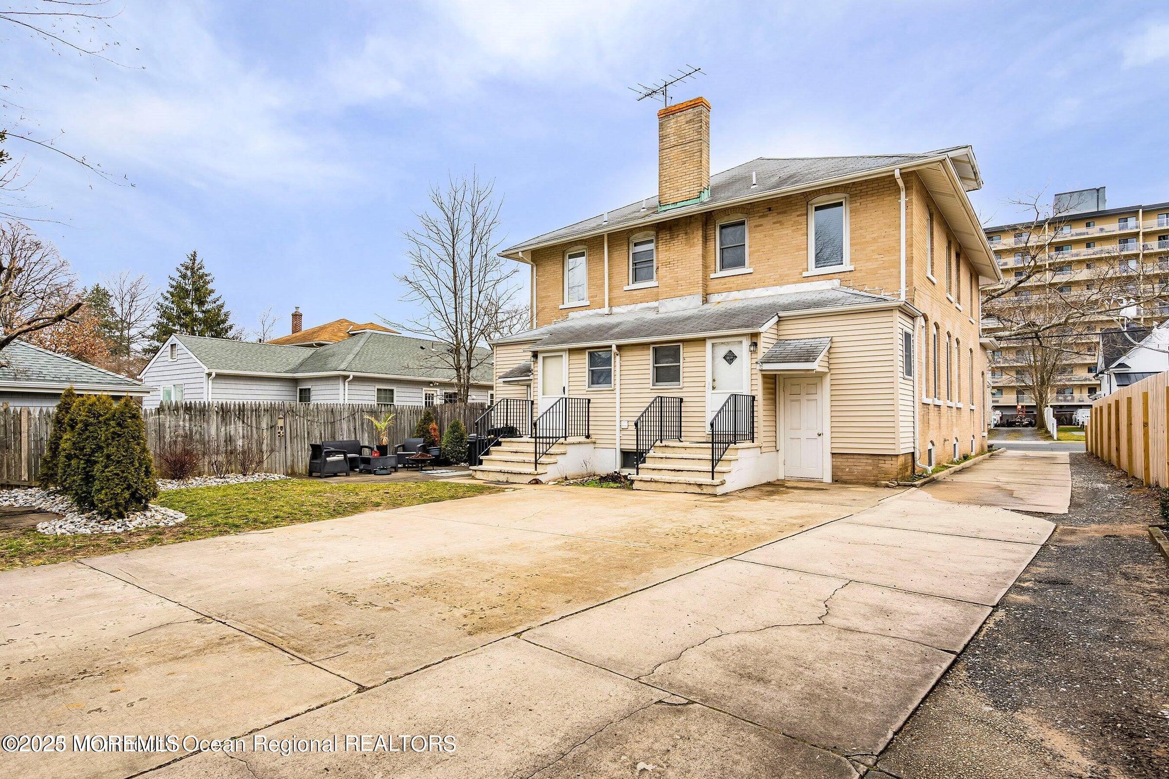 34 Bridge Avenue, Unit A Red Bank, NJ 07701 - Photo 25 of 27 a front view of a building with yard