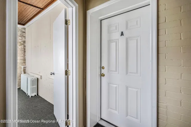 a view of a bathroom with white door