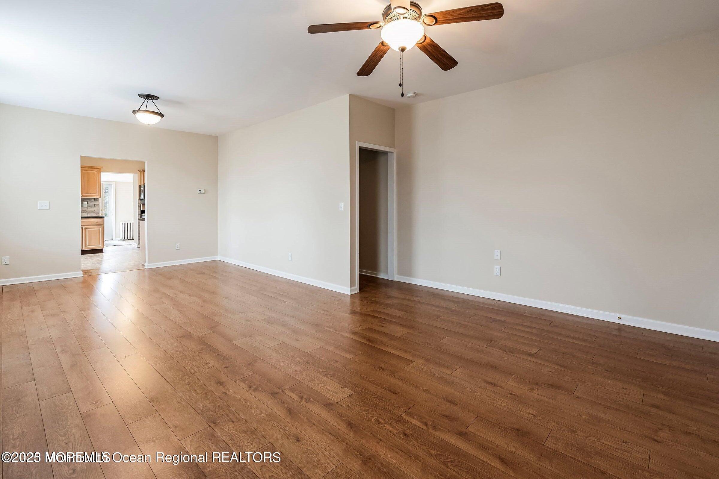 34 Bridge Avenue, Unit A Red Bank, NJ 07701 - Photo 7 of 27 a view of an empty room with wooden floor and chandelier