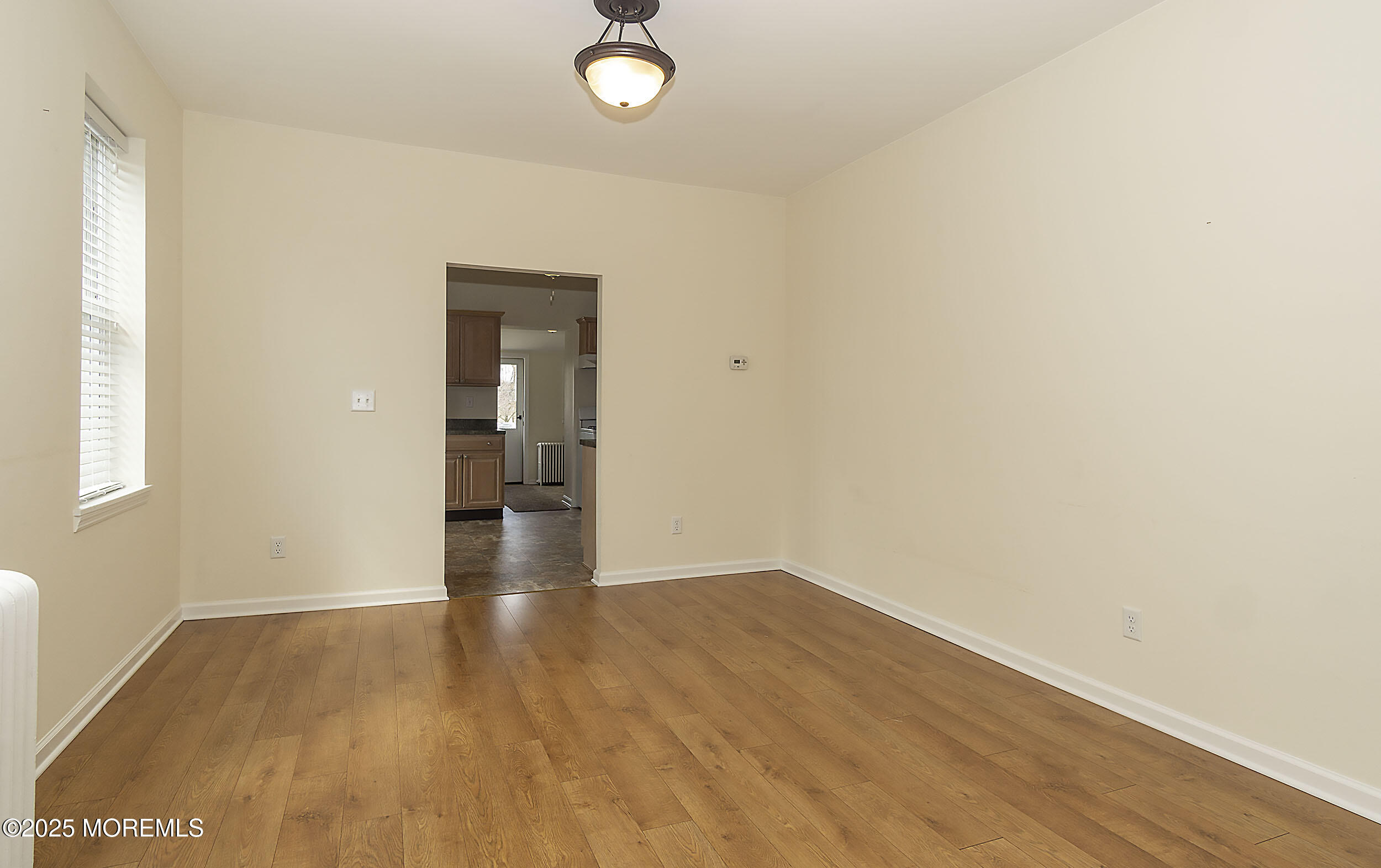 34 Bridge Avenue, Unit A Red Bank, NJ 07701 - Photo 8 of 27 an empty room with wooden floor and windows