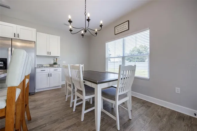 a living room with furniture a flat screen tv and a window