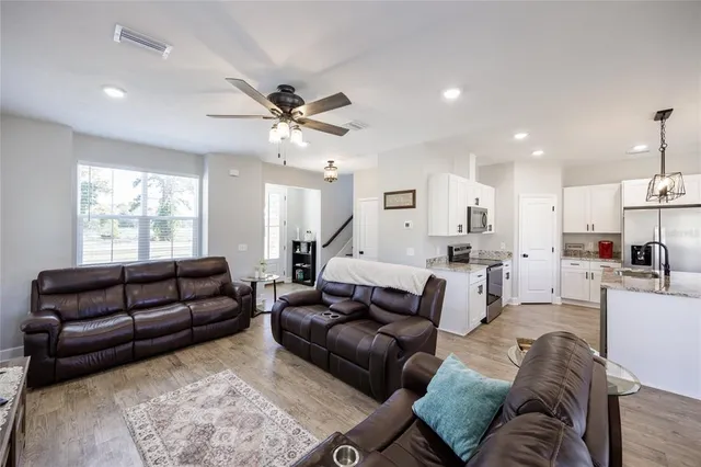 a bathroom with a granite countertop toilet sink and mirror