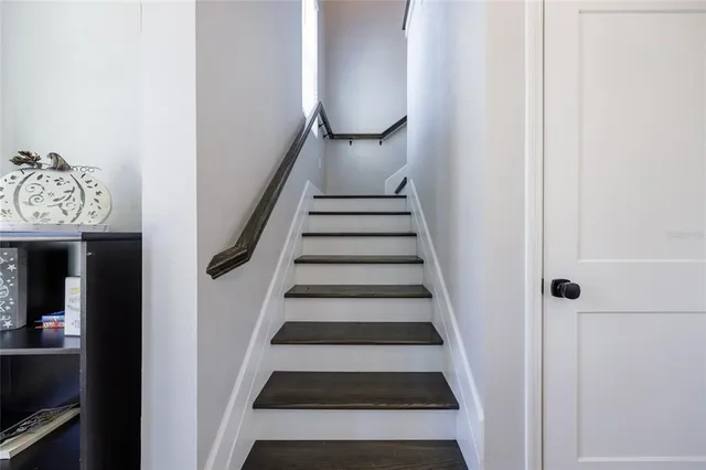 a view of entryway and hall with wooden floor