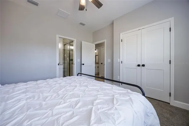 a bathroom with a granite countertop sink a mirror and shower