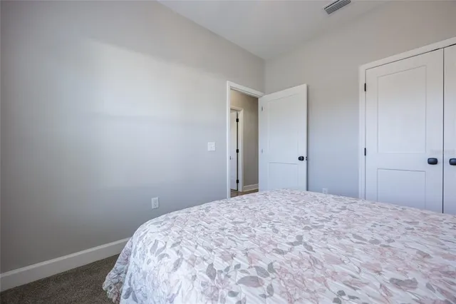 a bathroom with a granite countertop sink mirror vanity and toilet