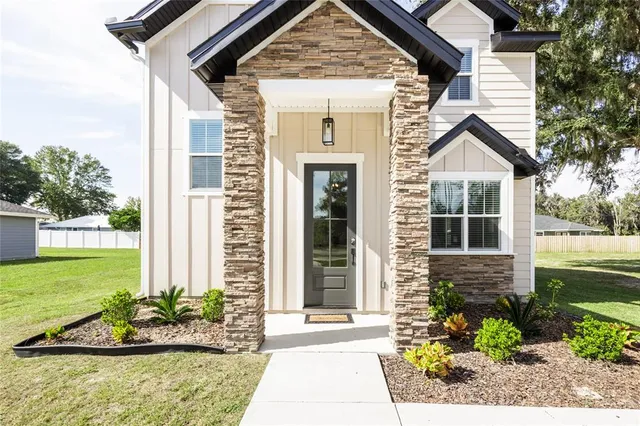 a view of an entryway with wooden floor and staircase