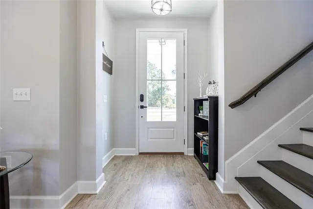 a large kitchen with stainless steel appliances granite countertop a large stove top oven a sink dishwasher and white cabinets