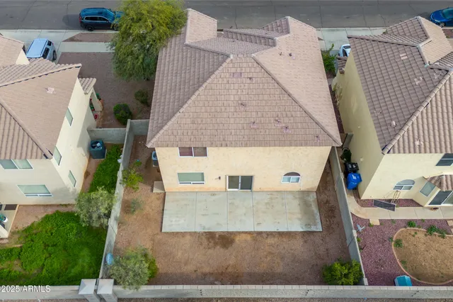 an aerial view of a house with a yard