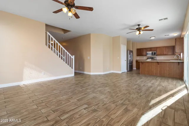 a view of a kitchen with a sink and a chandelier fan