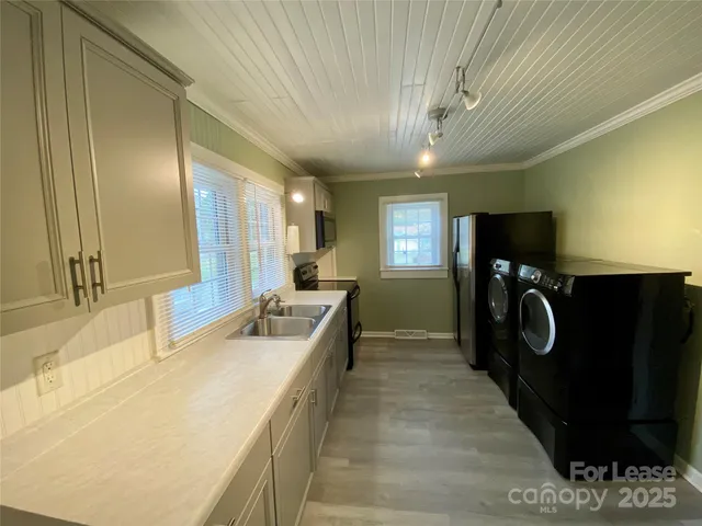 a bathroom with a sink mirror and shower
