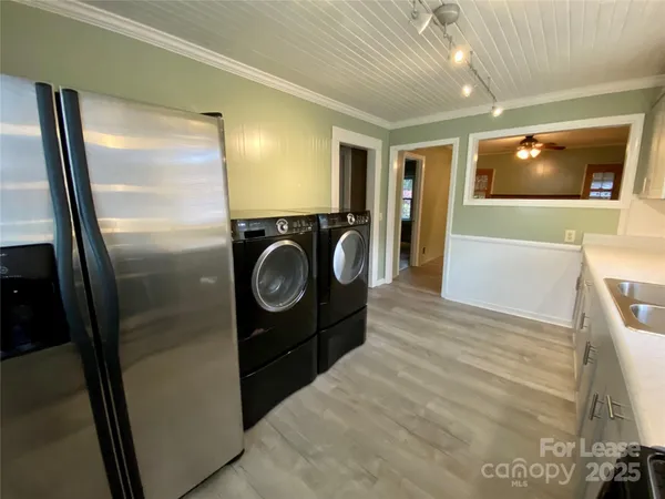 a view of a hallway with washer and dryer