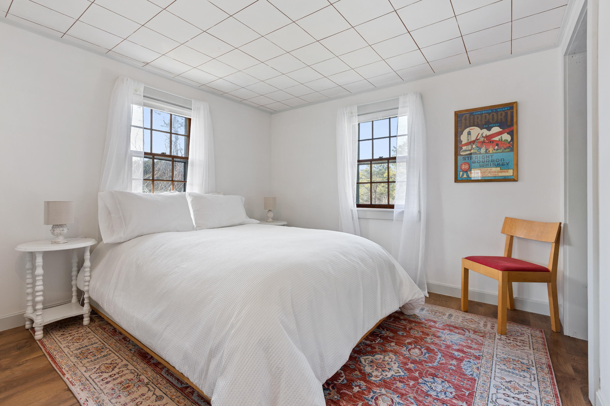 4 Perry Road Truro, MA 02666 - Photo 15 of 29 a large bed sitting in a bedroom next to a window and a chair