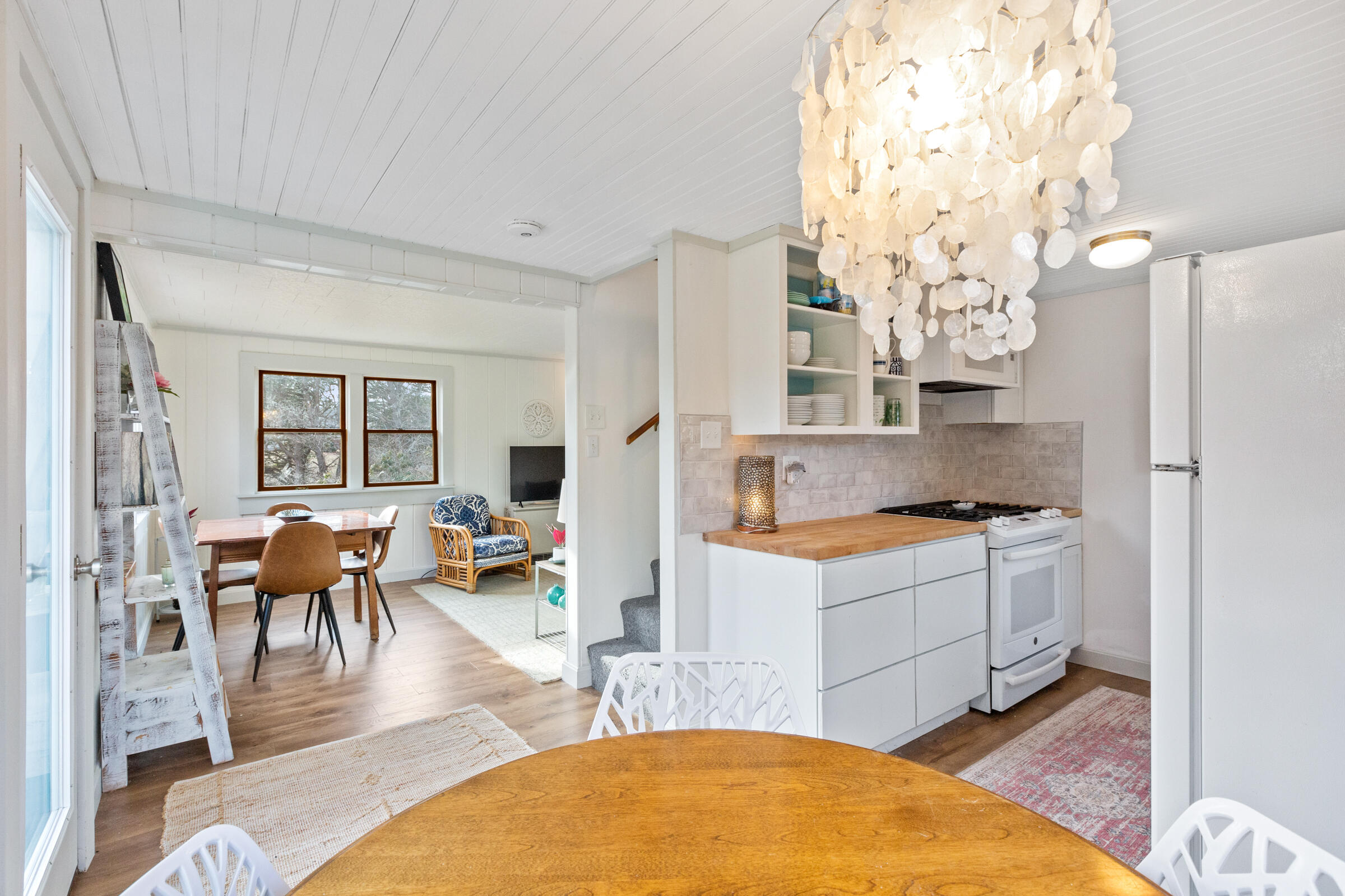 4 Perry Road Truro, MA 02666 - Photo 9 of 29 a kitchen with stainless steel appliances granite countertop a stove refrigerator and dining table with wooden floor