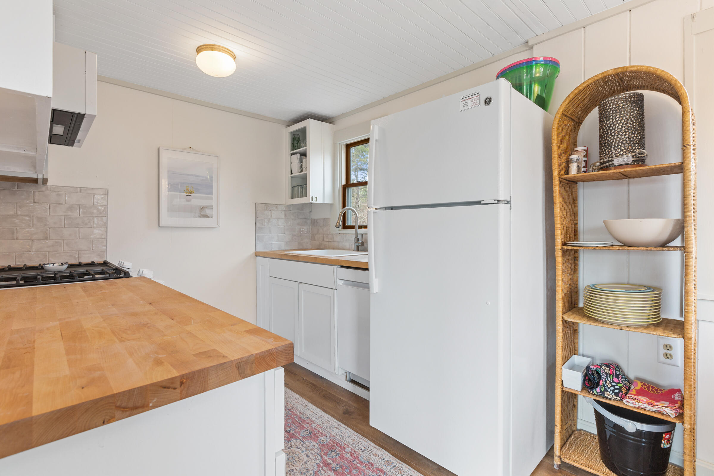 4 Perry Road Truro, MA 02666 - Photo 10 of 29 a kitchen with a refrigerator and a sink