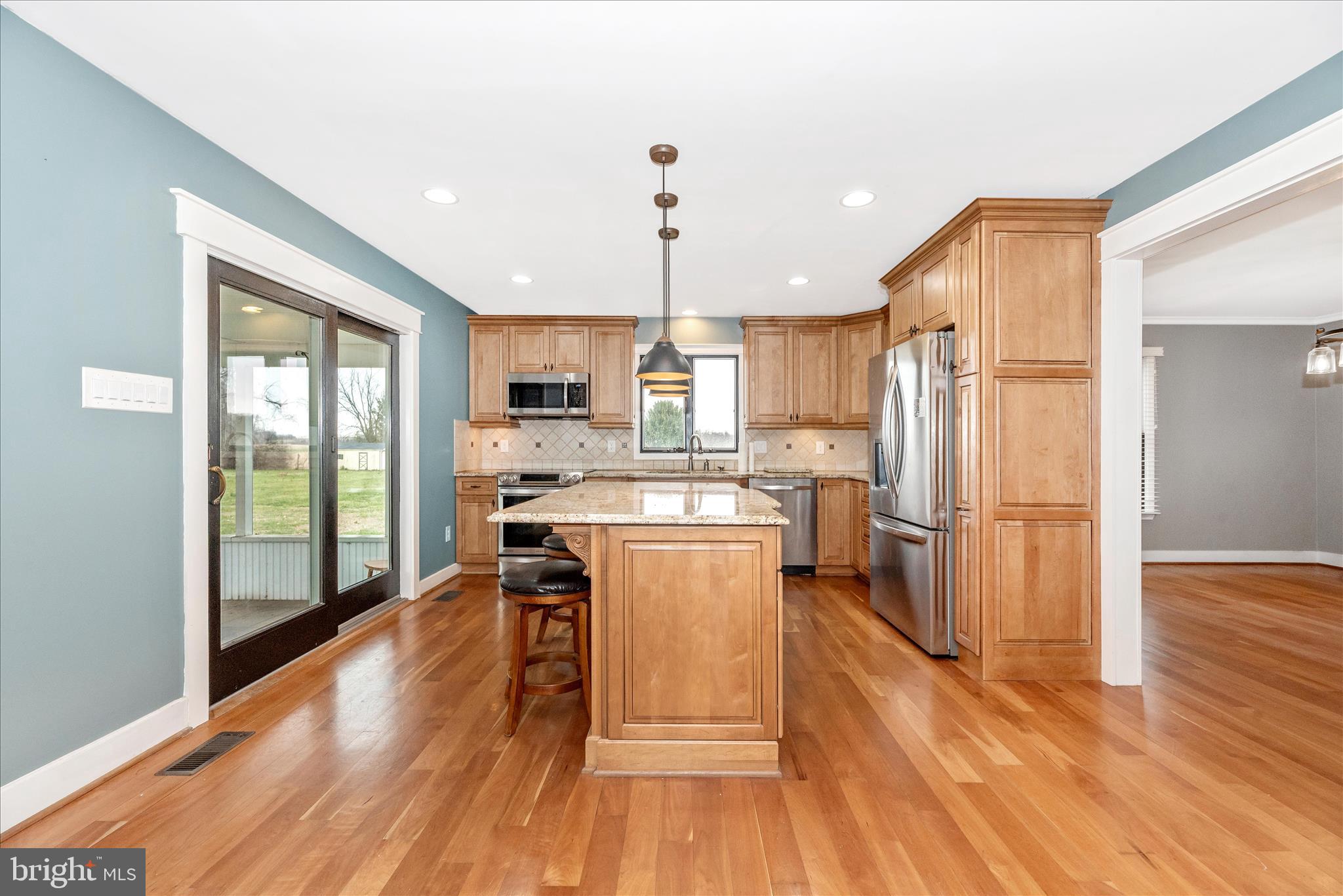 1150 Humbert Schoolhouse Road Westminster, MD 21158 - Photo 14 of 46 a kitchen with a refrigerator a stove and white cabinets with wooden floor