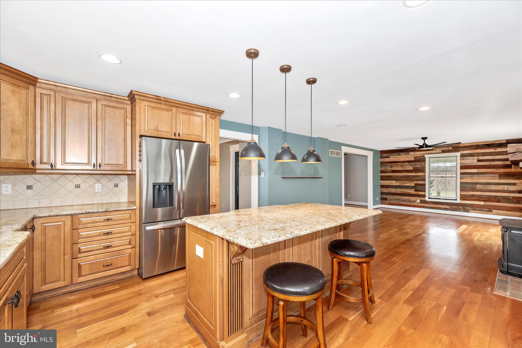 1150 Humbert Schoolhouse Road Westminster, MD 21158 - Photo 17 of 46 a kitchen with stainless steel appliances kitchen island granite countertop a refrigerator a stove and a wooden floors