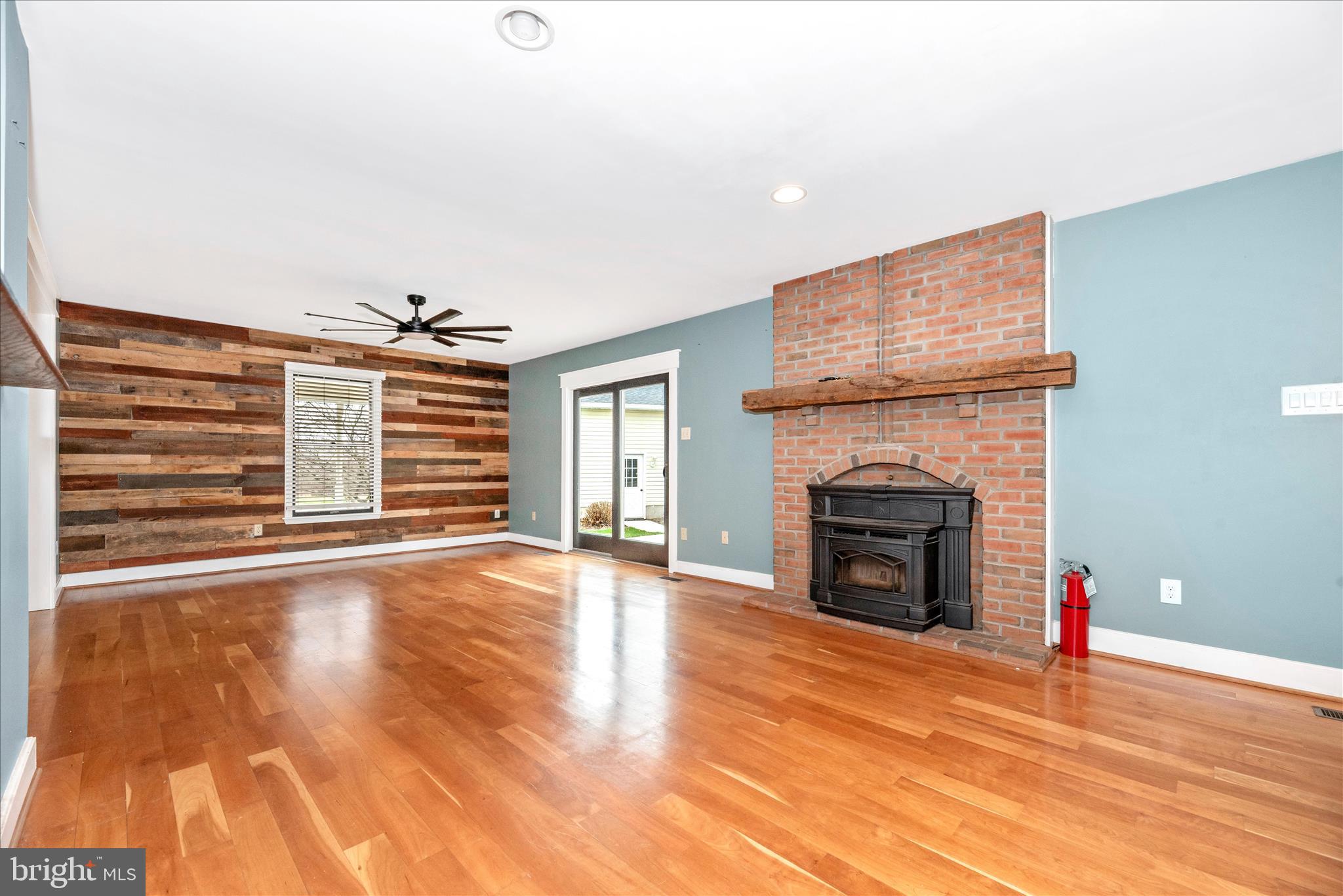 1150 Humbert Schoolhouse Road Westminster, MD 21158 - Photo 21 of 46 a view of an empty room with wooden floor fireplace and a window