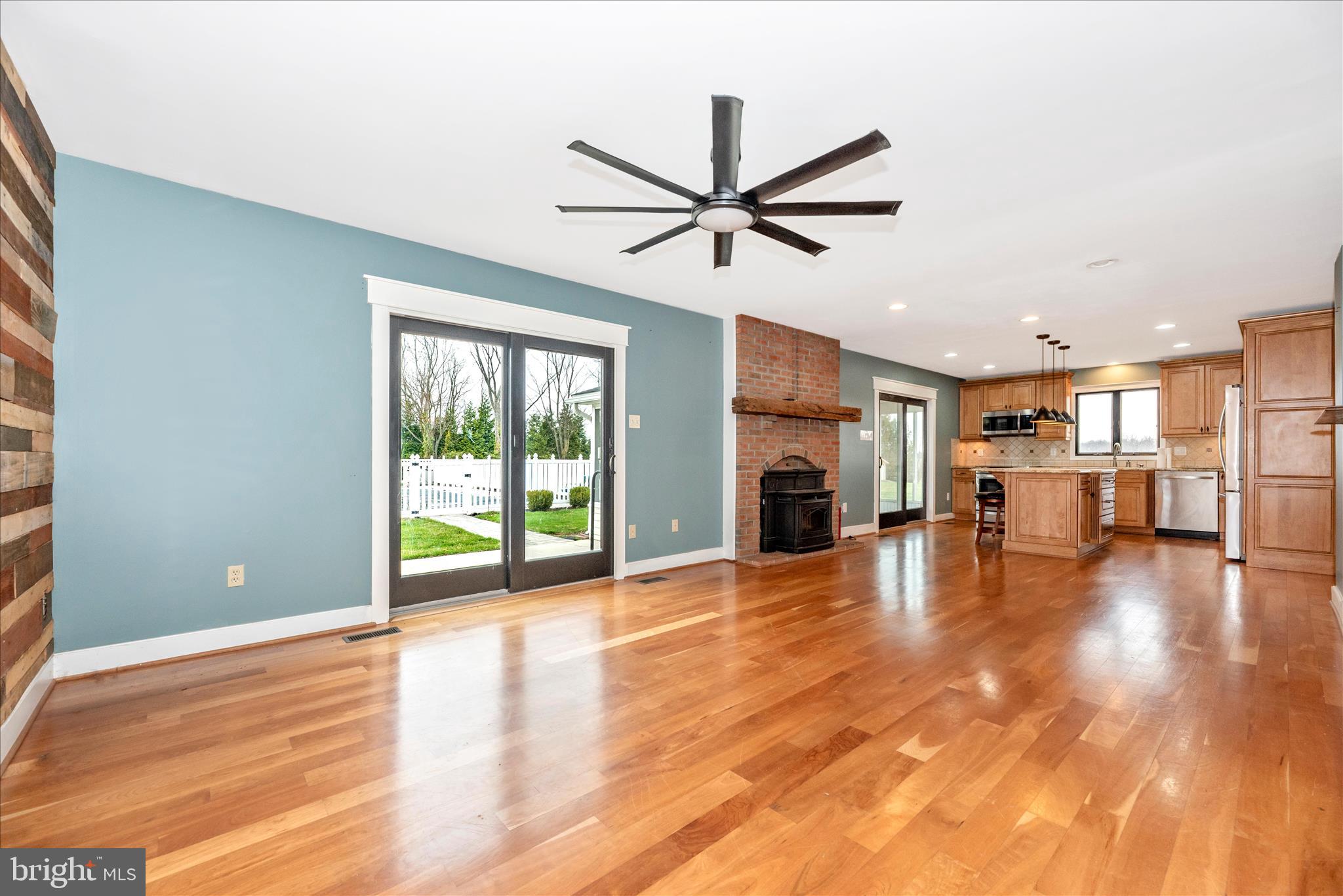1150 Humbert Schoolhouse Road Westminster, MD 21158 - Photo 22 of 46 a view of a livingroom with fireplace hardwood floor and a ceiling fan