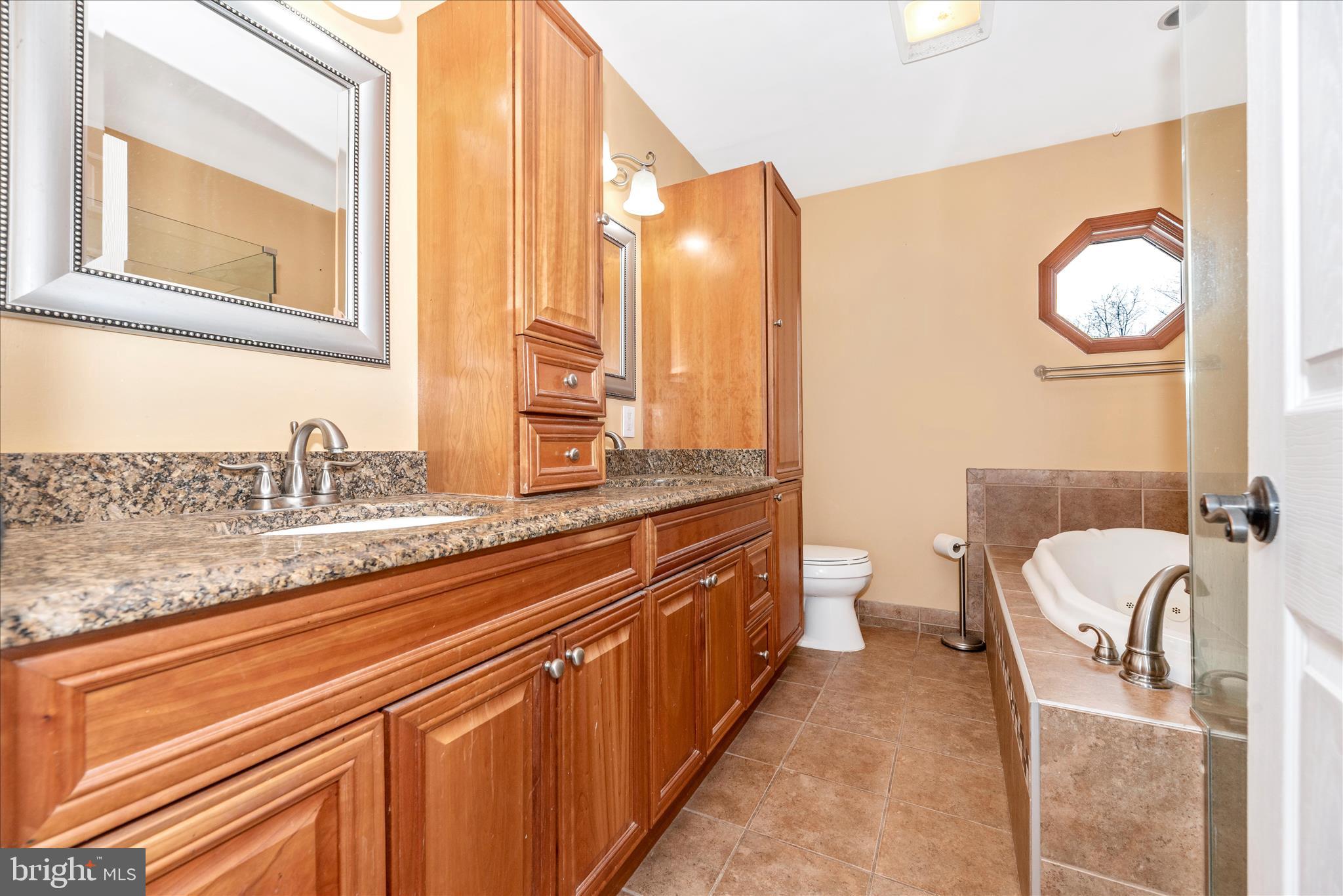 1150 Humbert Schoolhouse Road Westminster, MD 21158 - Photo 31 of 46 a spacious bathroom with a granite countertop sink and a mirror