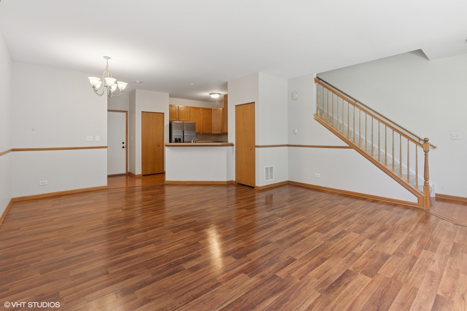 133 Springbrook Trail South Oswego, IL 60543 - Photo 2 of 29 a view of a kitchen with wooden floor and a hallway