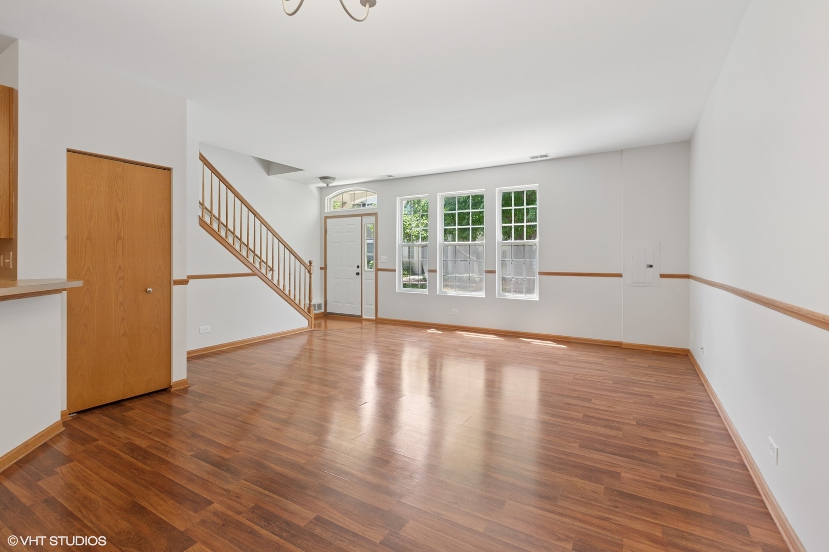133 Springbrook Trail South Oswego, IL 60543 - Photo 5 of 29 a view of an empty room with wooden floor and a window