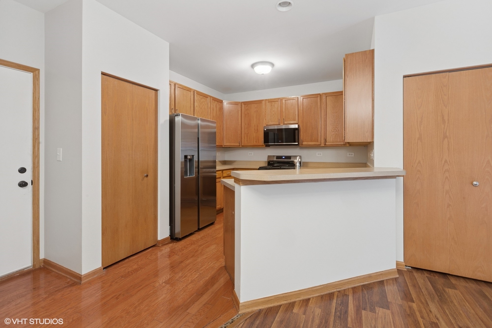 133 Springbrook Trail South Oswego, IL 60543 - Photo 7 of 29 a kitchen with stainless steel appliances a refrigerator and a stove top oven
