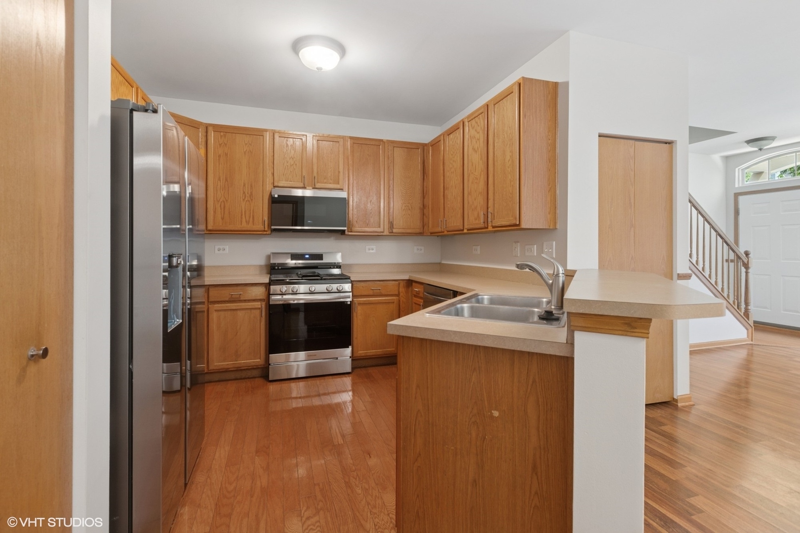 133 Springbrook Trail South Oswego, IL 60543 - Photo 8 of 29 a kitchen with a stove a sink and a microwave