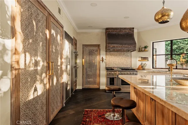 a kitchen with stainless steel appliances granite countertop a sink and a refrigerator
