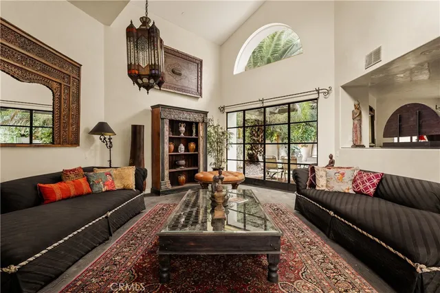 a living room with furniture fireplace and window