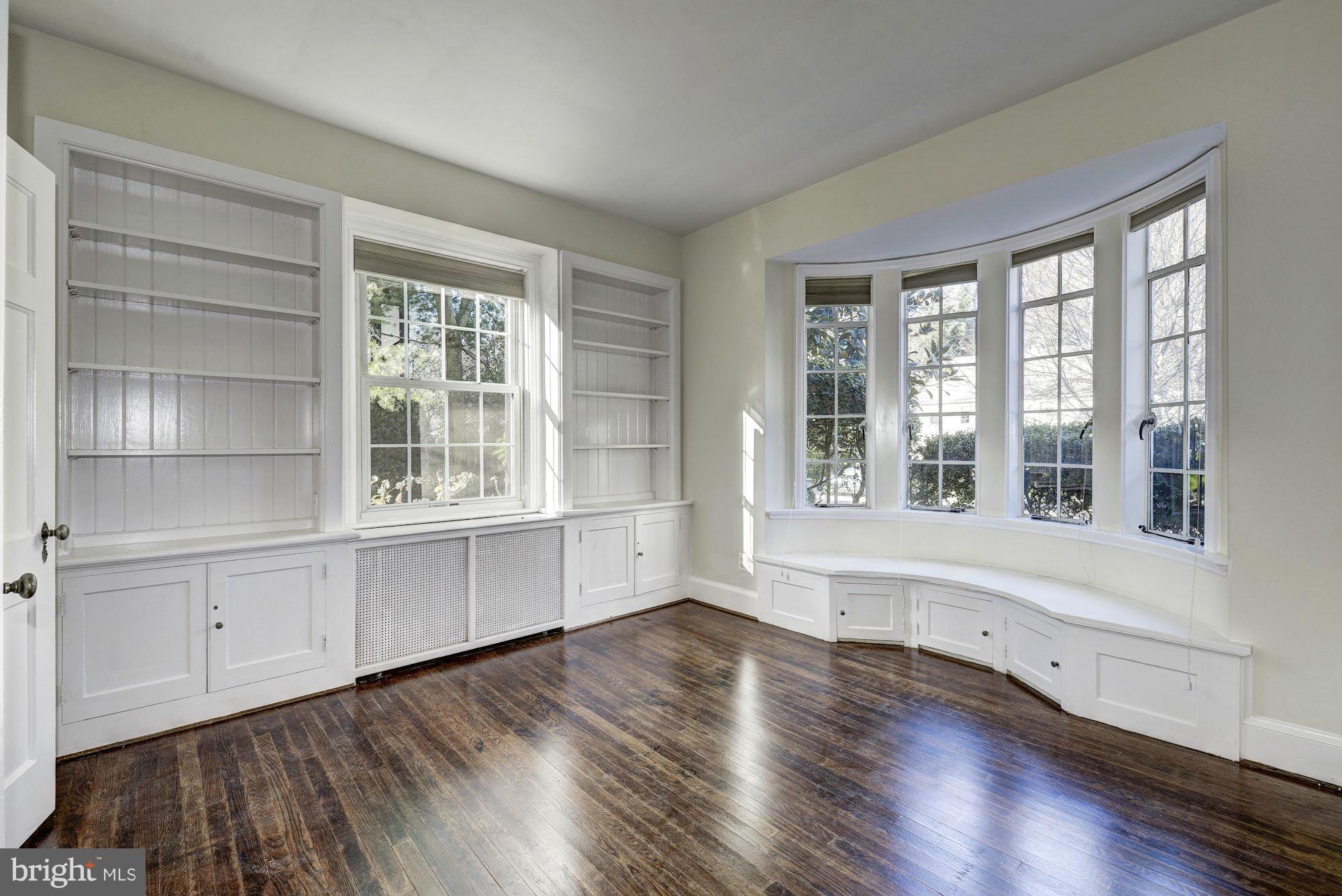 4910 Hillbrook Lane Northwest Washington, DC 20016 - Photo 11 of 30 a view of an empty room with a window and wooden floor