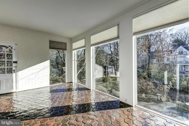a view of a hallway with windows and stairs