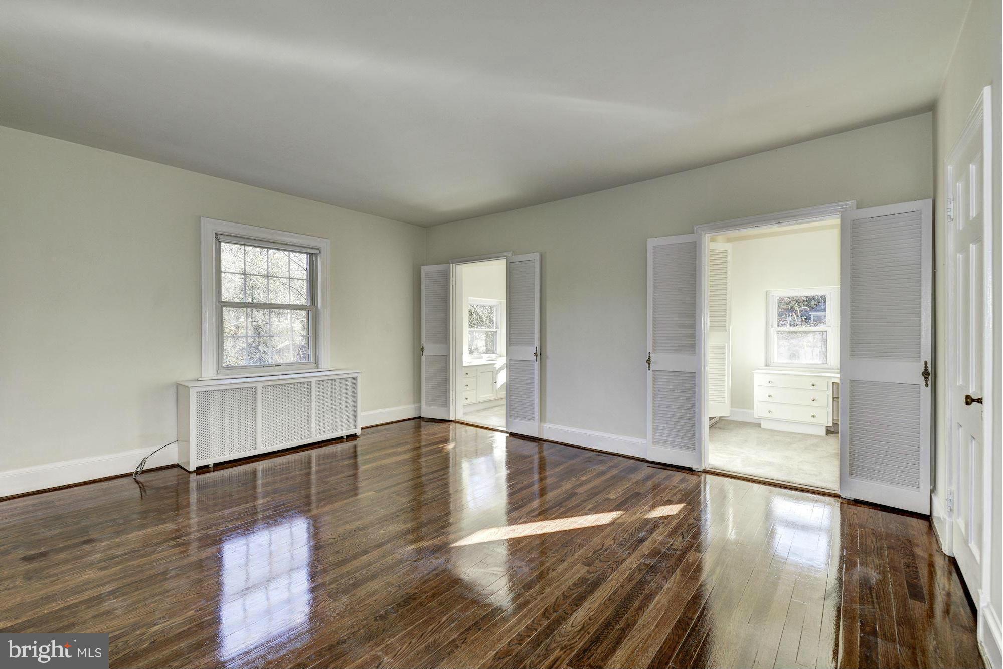 4910 Hillbrook Lane Northwest Washington, DC 20016 - Photo 14 of 30 wooden floor in an empty room with a window