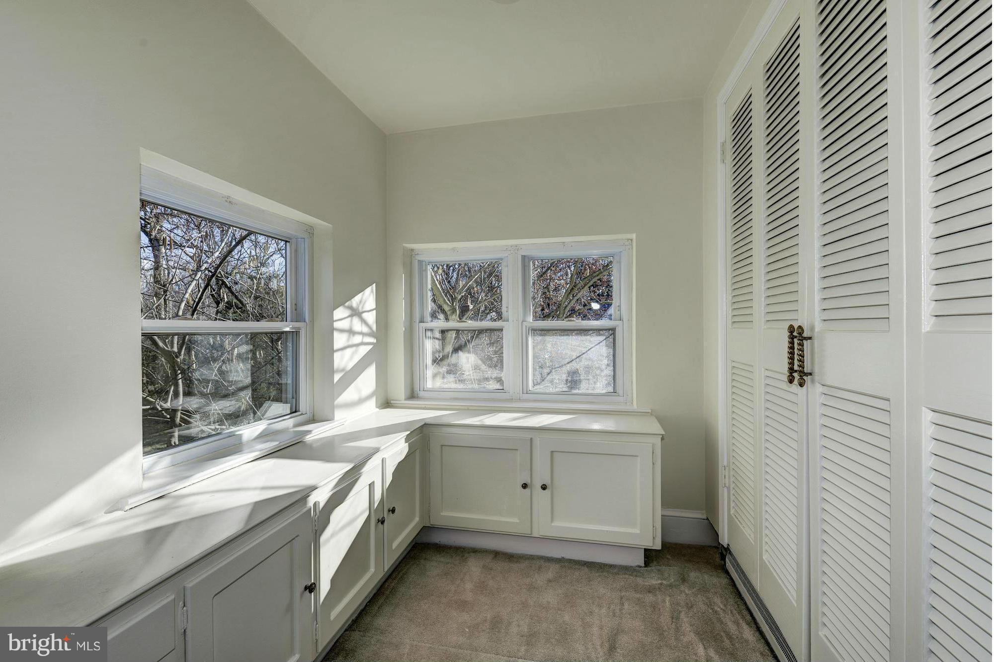 4910 Hillbrook Lane Northwest Washington, DC 20016 - Photo 16 of 30 a bathroom with a granite countertop sink a large window and a bathtub