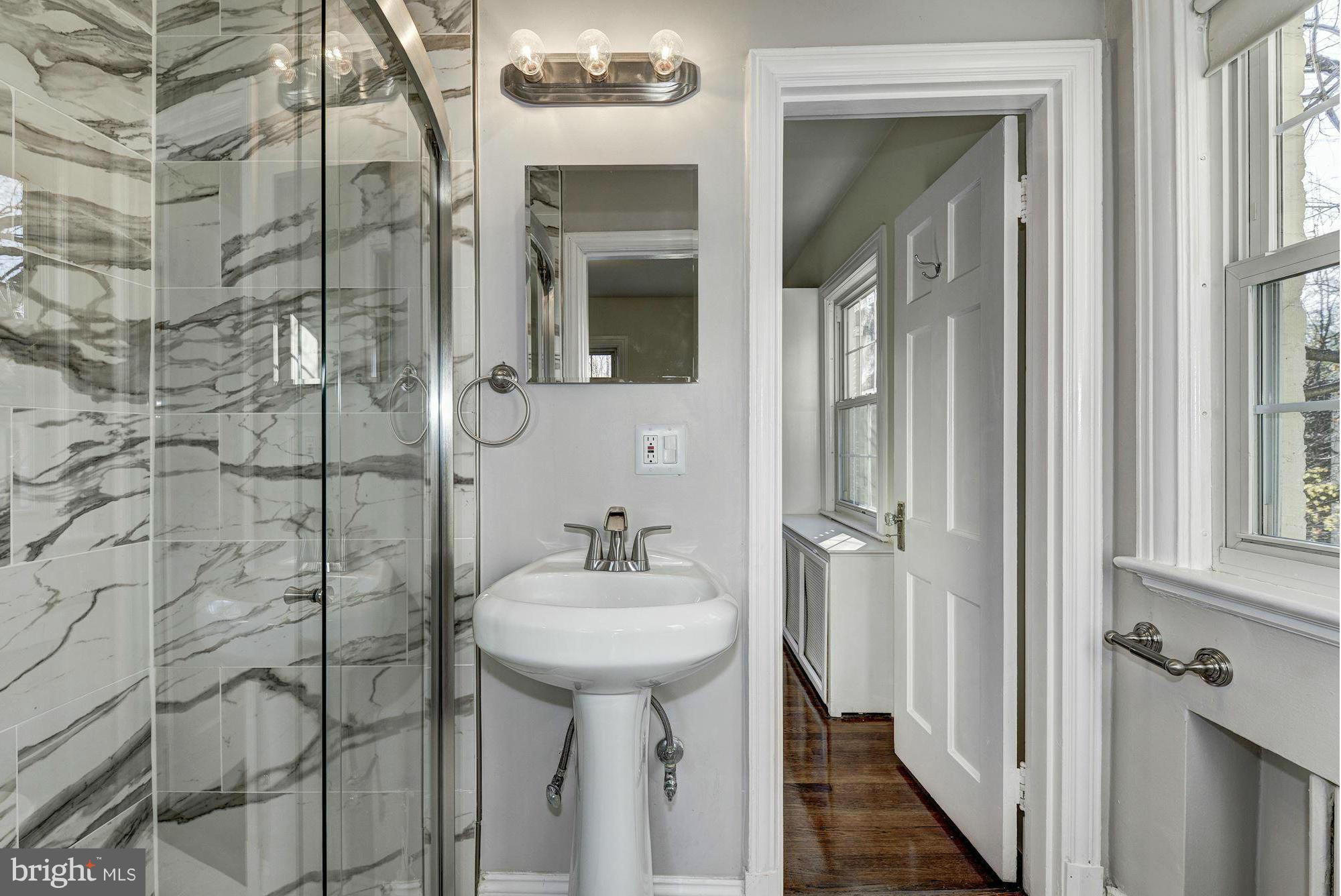 4910 Hillbrook Lane Northwest Washington, DC 20016 - Photo 19 of 30 a bathroom with a sink and mirror