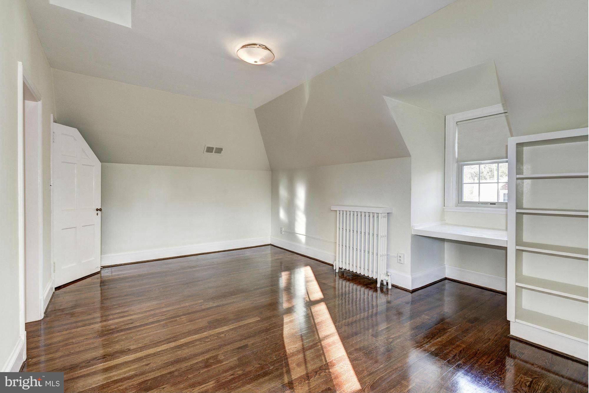 4910 Hillbrook Lane Northwest Washington, DC 20016 - Photo 22 of 30 an empty room with wooden floor and windows