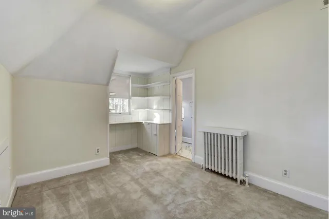 a bathroom with a granite countertop sink a mirror and shower