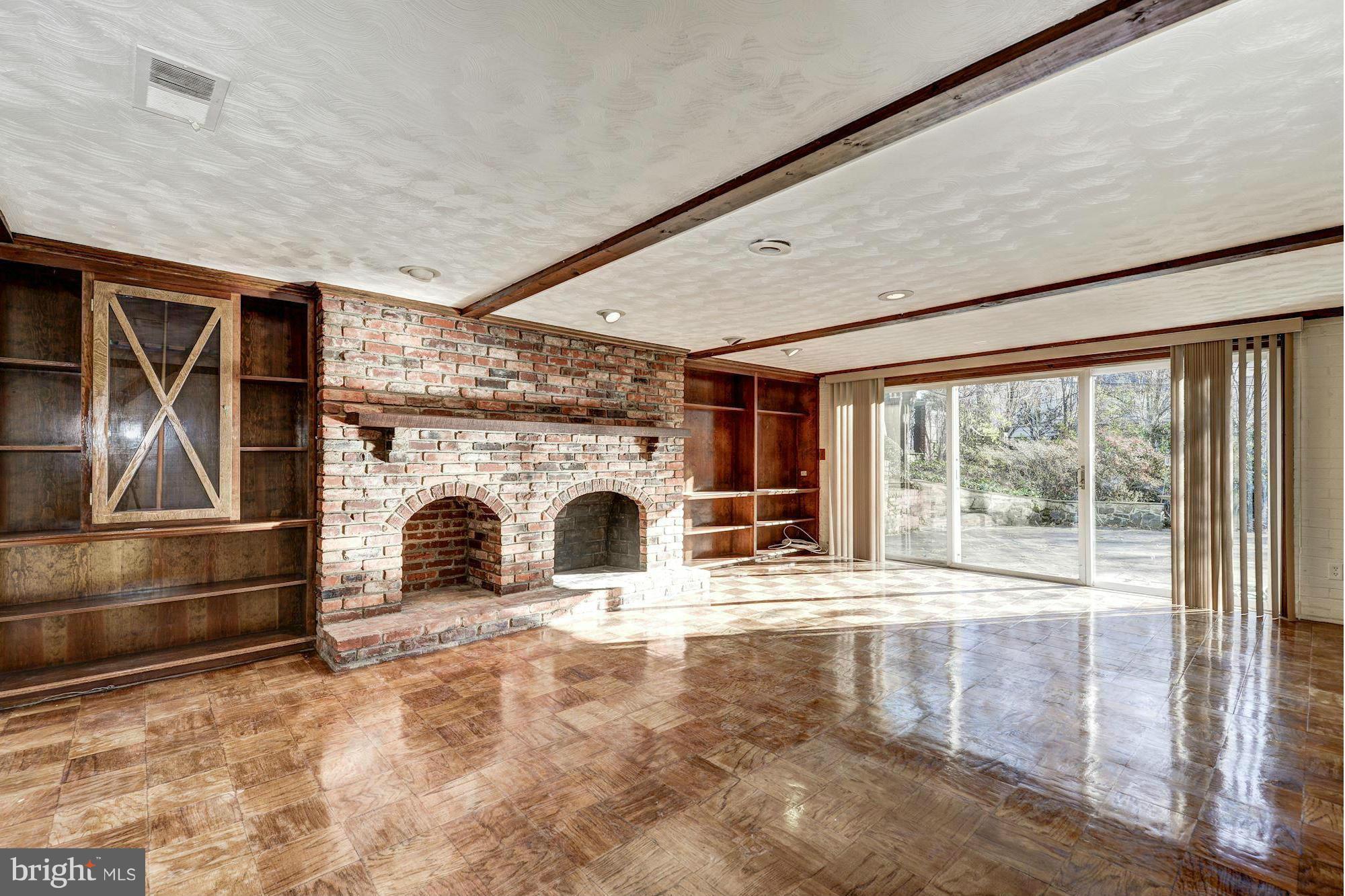 4910 Hillbrook Lane Northwest Washington, DC 20016 - Photo 25 of 30 a view of empty room with floor to ceiling window and fireplace