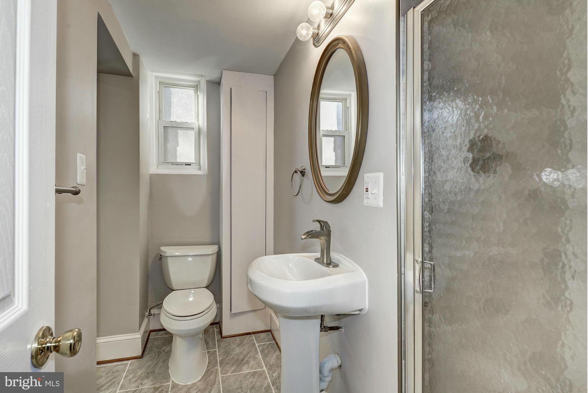 4910 Hillbrook Lane Northwest Washington, DC 20016 - Photo 27 of 30 a bathroom with a toilet sink and mirror