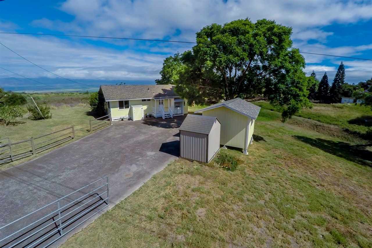 1297 Lower Kula Road Kula, HI 96790 - Photo 2 of 30 a view of a garden with lawn chairs and a fire pit