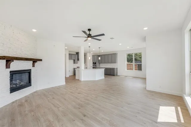 a view of a kitchen with a sink and a fireplace