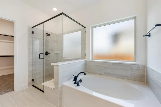 a bathroom with a bathtub and a shower