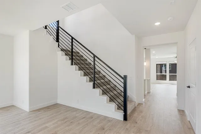 a view of entryway and hall with wooden floor