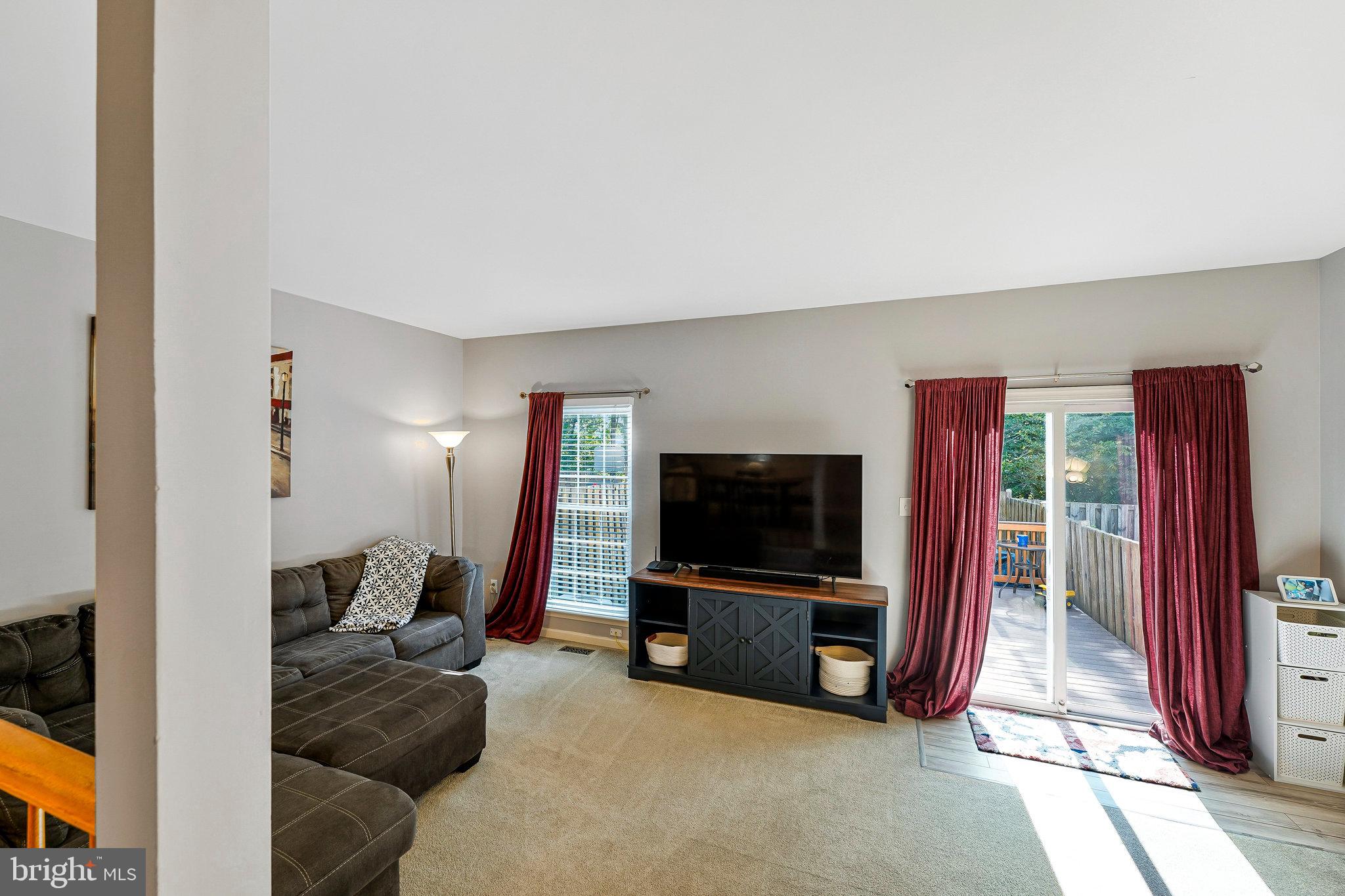 1085 Smartts Lane Northeast Leesburg, VA 20176 - Photo 15 of 38 a living room with furniture and a flat screen tv